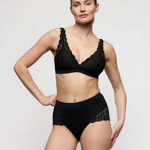 Model wearing Marie Jo Soft Studio Smoothing Briefs in Black paired with lace bralette, showcasing comfort and style.