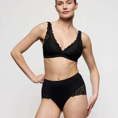 Model wearing Marie Jo Soft Studio Smoothing Briefs in Black paired with lace bralette, showcasing comfort and style.