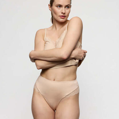 Model showcasing luxury thong underwear in Caffe Latte, emphasizing softness and comfort, ideal for a seamless look.