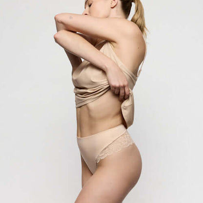 Model wearing Marie Jo Soft Studio luxury thong underwear in Caffe Latte, showcasing exquisite softness and a streamlined look.