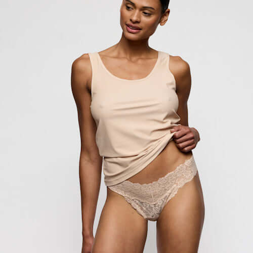 Marie Jo Soft Studio Thong in Caffe Latte showcased with a soft tank top, emphasizing comfort and a streamlined look.