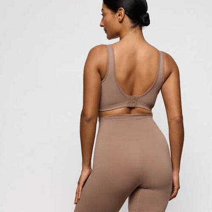 Primadonna Nudda Shapewear in Ginger high briefs with legs worn by a model from the back, showcasing smooth anti-chafing design.