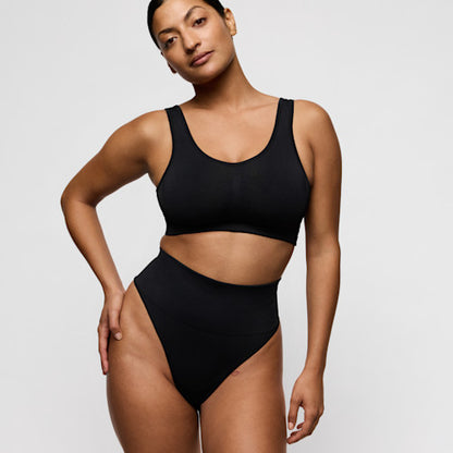 Primadonna NUDDA bralette in black worn by a model with high-waisted black underwear.