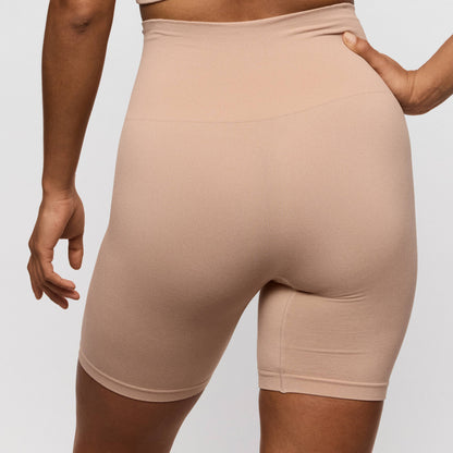 Primadonna Nudda shapewear high briefs with legs in caffe latte shown from behind, highlighting the smooth and comfortable design.