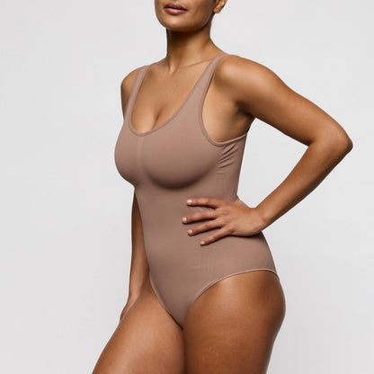 Primadonna NUDDA shapewear body in ginger displayed on a model, showcasing a smooth silhouette and built-in wireless bra.
