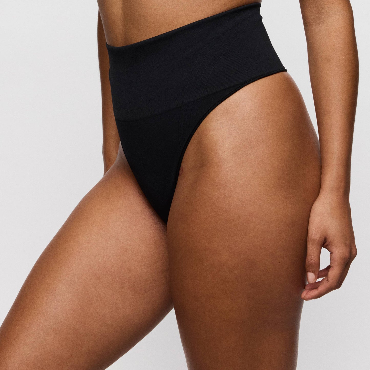 Primadonna NUDDA shapewear thong in black, high-waisted smoothing design, showcasing comfort and style.