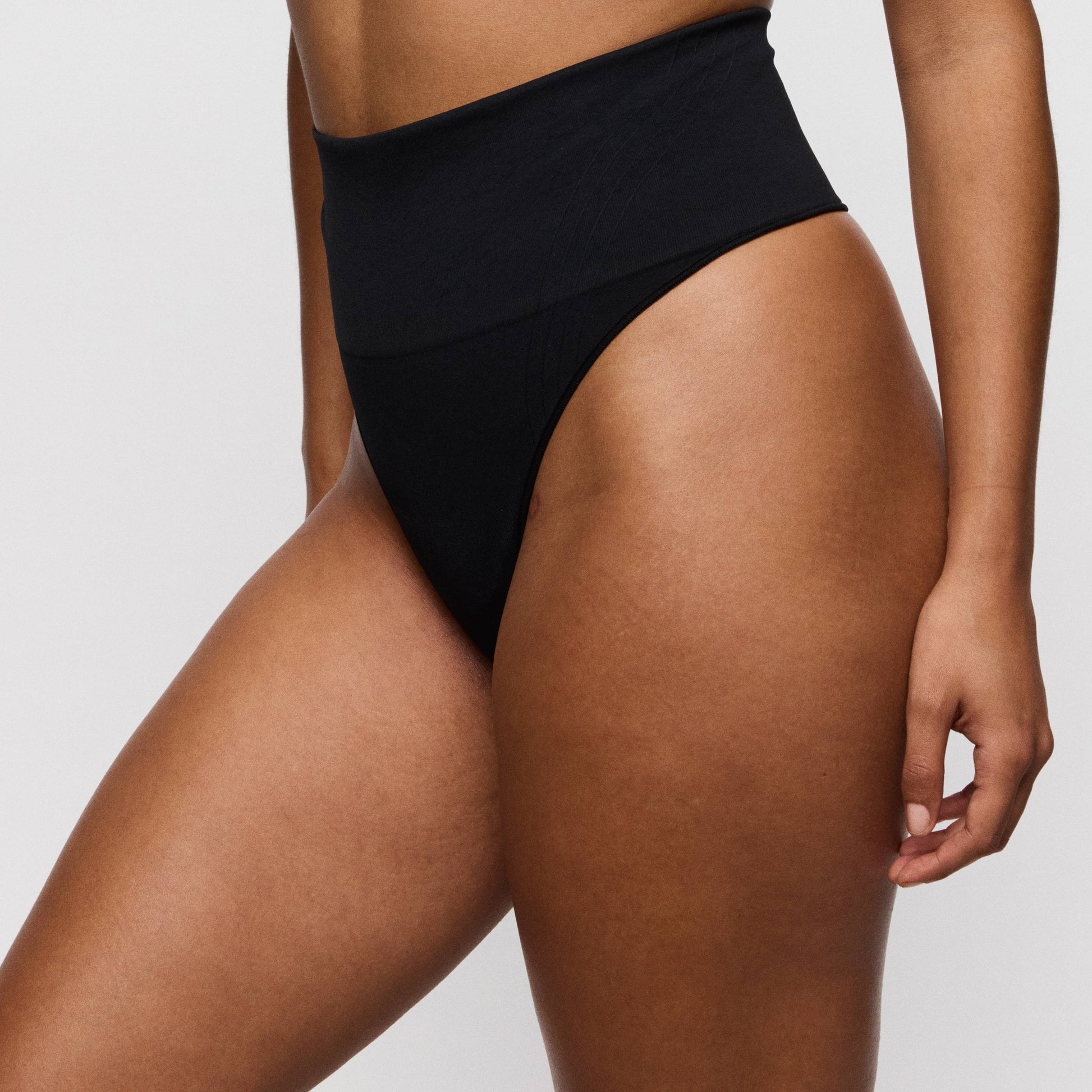 Primadonna NUDDA shapewear thong in black, high-waisted smoothing design, showcasing comfort and style.